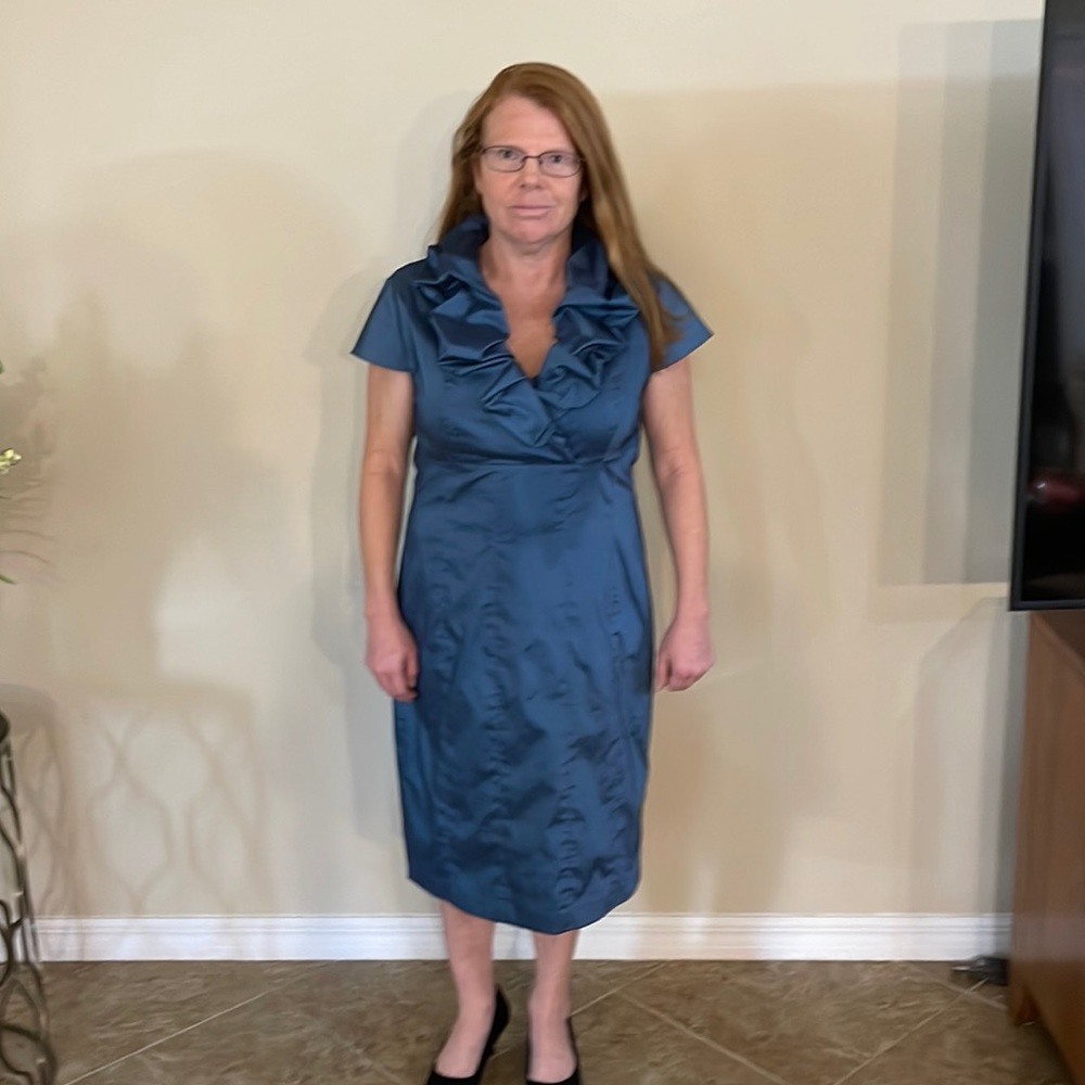 A dress full of beautiful ruffles around the top, metallic green-blue, lined